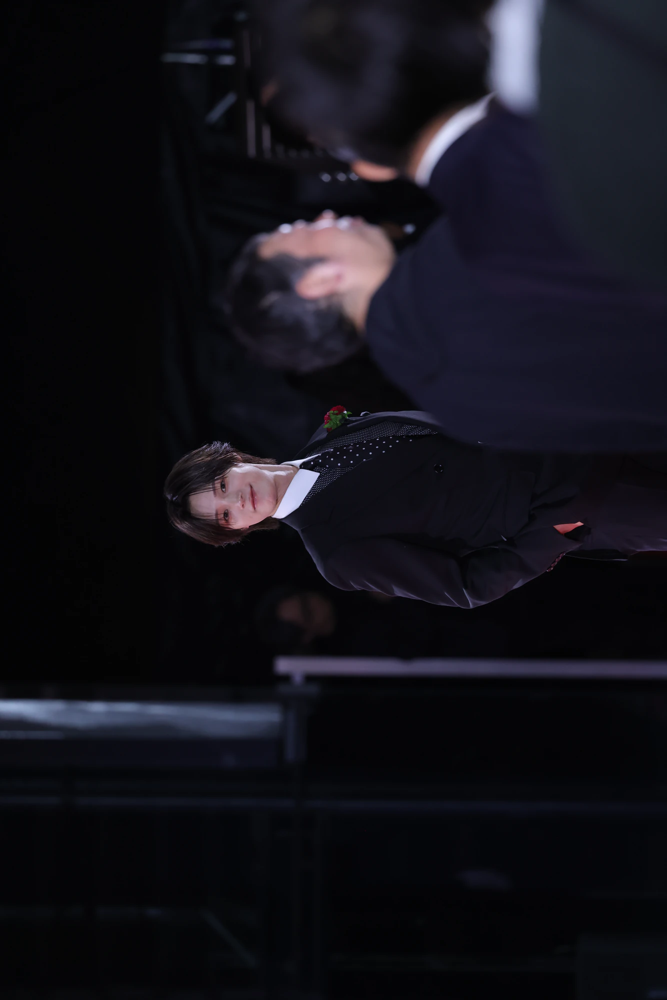 K performing on stage during a live performance.