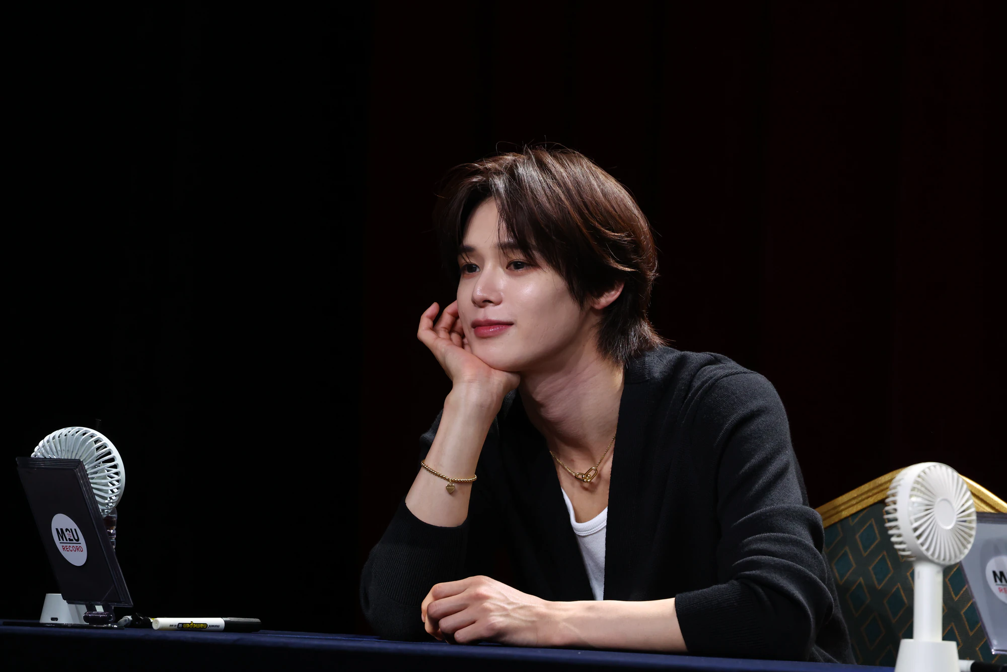 K in a distinctive look, captured during an appearance.