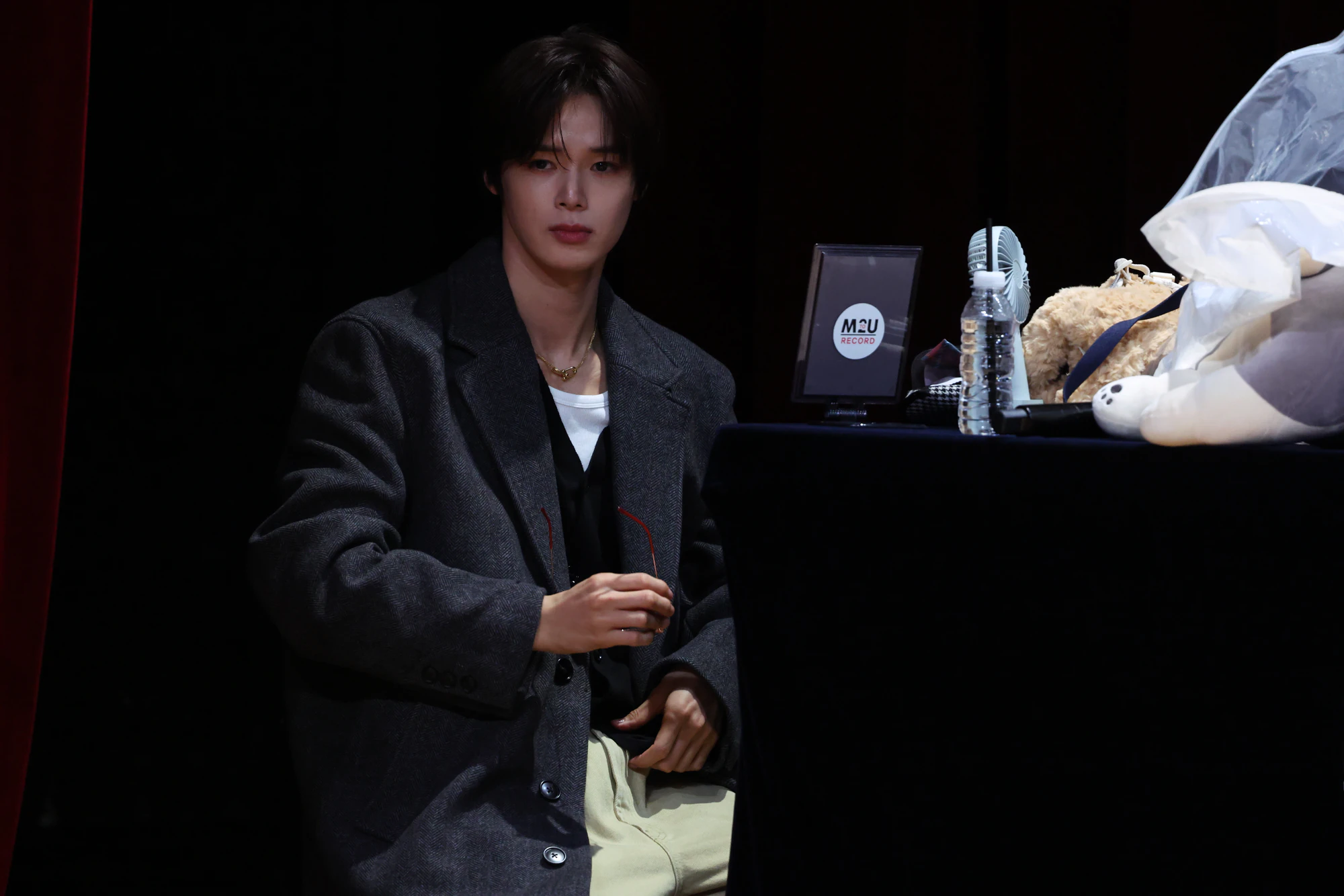 K in a distinctive look, captured during an appearance.